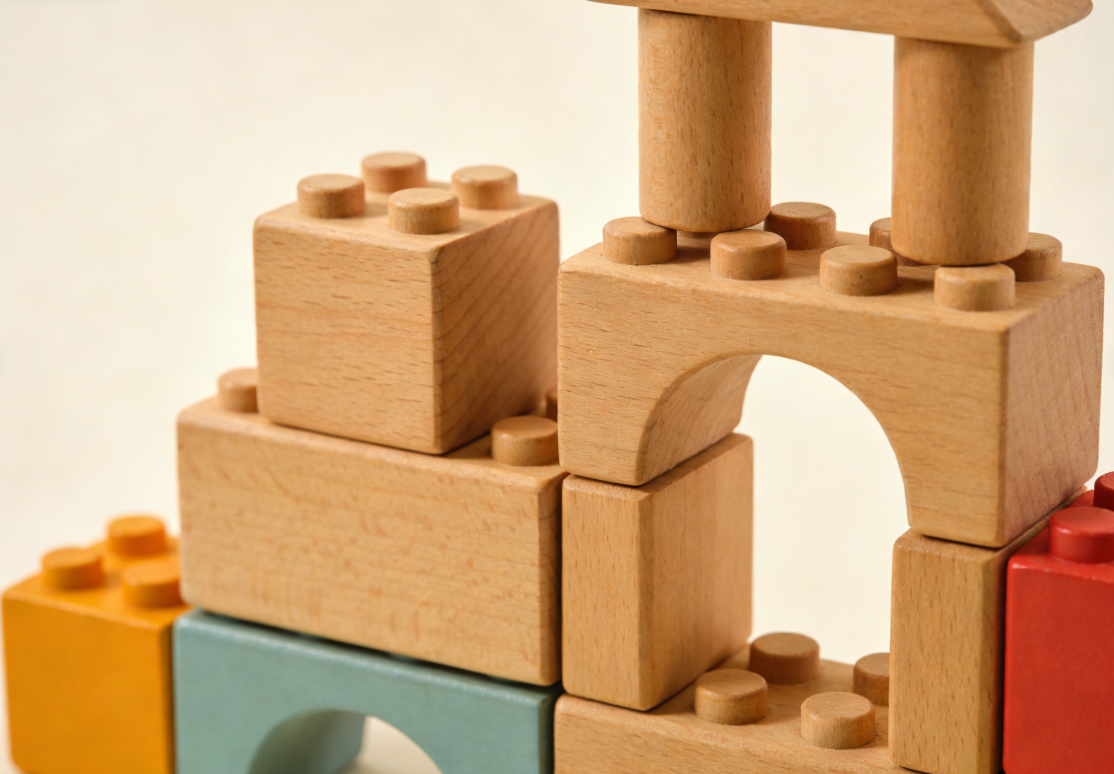 Close-up of wooden building blocks stacked in various constructions, showcasing the warmth and texture of natural wood