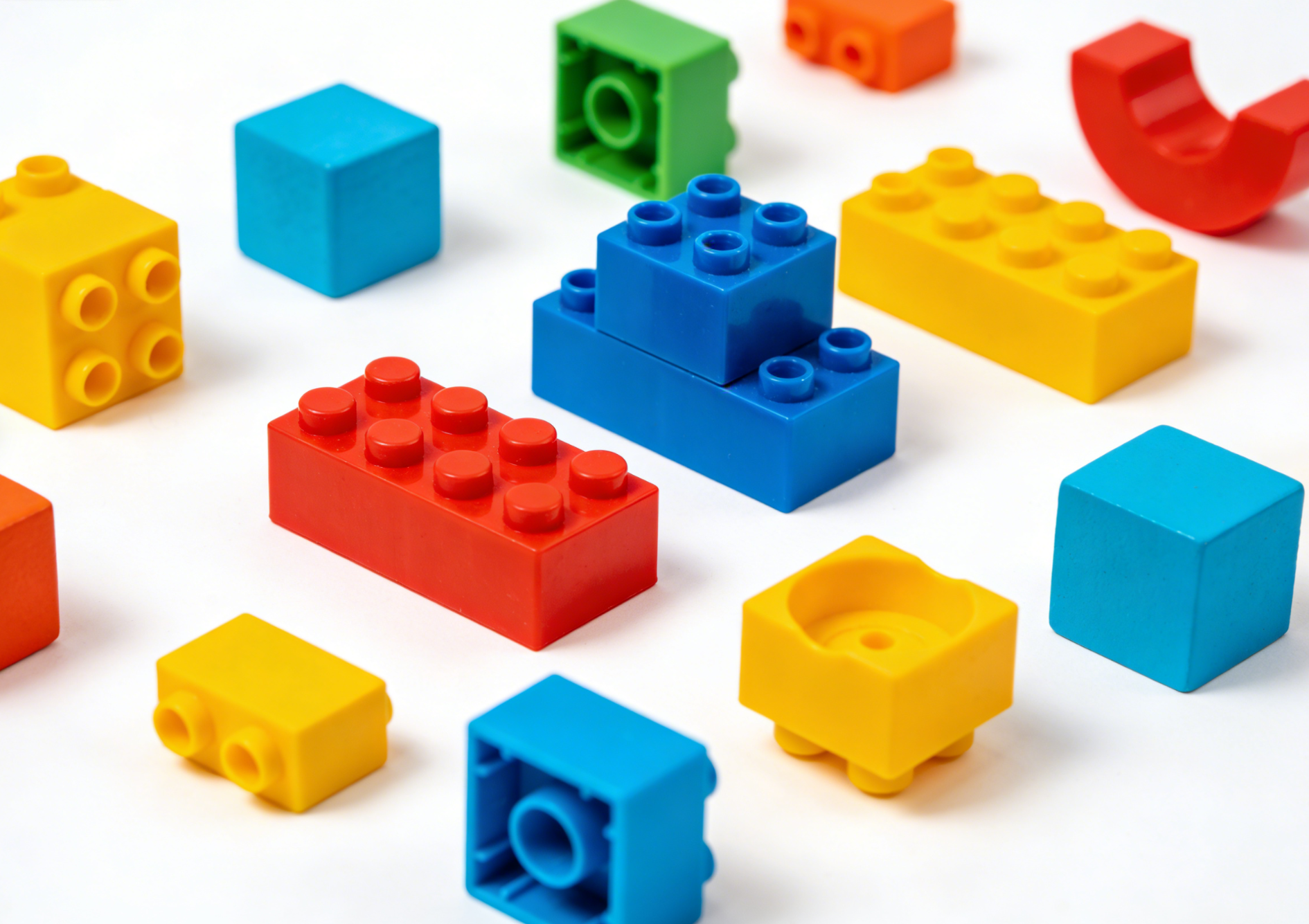 Children playing with interlocking block building sets creating a colorful structure